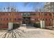 Brick apartment building entrance with a covered walkway and mature landscaping at 91 Rumson Ne Rd # C32, Atlanta, GA 30305