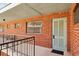 Brick exterior with an apartment entrance and railing outside the unit door at 91 Rumson Ne Rd # C32, Atlanta, GA 30305