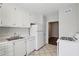 Cozy kitchen with white appliances and a view into the adjacent room at 91 Rumson Ne Rd # C32, Atlanta, GA 30305
