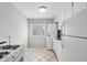Functional kitchen with white appliances, tile flooring, and ample natural light at 91 Rumson Ne Rd # C32, Atlanta, GA 30305