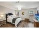 Bright bedroom with hardwood floors, two windows, and a comfortable bed at 1605 Beaumont Cir, Duluth, GA 30096