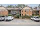 Exterior view of a brick apartment complex with well-maintained landscaping and ample parking at 1605 Beaumont Cir, Duluth, GA 30096