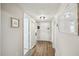 Inviting hallway with wood floors, neutral paint, and stylish decor elements. est. 2022 at 1605 Beaumont Cir, Duluth, GA 30096