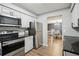 Well-equipped kitchen with stainless appliances, granite counters, and access to dining area at 1605 Beaumont Cir, Duluth, GA 30096