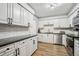 Bright kitchen with white cabinets, stainless steel appliances, and subway tile backsplash at 1605 Beaumont Cir, Duluth, GA 30096