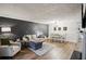 Open living room boasts modern accent wall, hardwood floors, and natural light throughout at 1605 Beaumont Cir, Duluth, GA 30096
