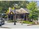 View of the restaurant with stone facade, outdoor seating and trees at 1605 Beaumont Cir, Duluth, GA 30096