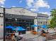 Charming restaurant exterior with outdoor seating under blue umbrellas on a sunny day at 1605 Beaumont Cir, Duluth, GA 30096