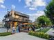 Outdoor dining area with lush landscaping and people enjoying the restaurant's amenities at 1605 Beaumont Cir, Duluth, GA 30096