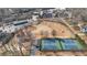 Wide aerial shot showing a neighborhood park featuring two tennis courts and sports fields at 174 Sidney St, Marietta, GA 30060