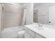 Clean bathroom featuring neutral tile, a tub/shower combo, and a white vanity with modern fixtures at 174 Sidney St, Marietta, GA 30060