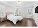 Bright bedroom featuring tray ceilings, wood floors, and natural light from windows with shutters at 174 Sidney St, Marietta, GA 30060