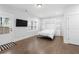 Bright bedroom featuring hardwood flooring, large windows, and a Murphy bed for flexible living at 174 Sidney St, Marietta, GA 30060