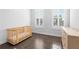 Bedroom featuring hardwood floors, natural light, and a wooden crib at 174 Sidney St, Marietta, GA 30060