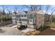 View of new construction townhomes with brick and stone exteriors, front-entry garages, and manicured landscaping at 174 Sidney St, Marietta, GA 30060