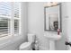 Charming half bathroom with pedestal sink, modern fixtures, and natural light at 174 Sidney St, Marietta, GA 30060