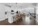 Open kitchen with white cabinets, quartz countertops, stainless appliances, and bar stool seating at 174 Sidney St, Marietta, GA 30060
