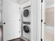 Stacked washer and dryer with accenting tile in laundry closet at 174 Sidney St, Marietta, GA 30060