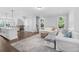 Open concept living area with hardwood floors, an island bar, and a staircase at 174 Sidney St, Marietta, GA 30060