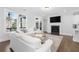 Open concept living room with white sofas, fireplace, hardwood floors, and natural light at 174 Sidney St, Marietta, GA 30060