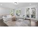 Bright living room featuring hardwood floors, neutral colors, and french doors leading to a deck at 174 Sidney St, Marietta, GA 30060