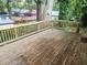 Spacious wooden back deck with railing overlooks a lush backyard, offering privacy and a tranquil outdoor space at 998 Allene Sw Ave, Atlanta, GA 30310