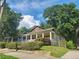 Quaint single-story home featuring a lovely front porch nestled among mature trees, creating a serene and inviting ambiance at 998 Allene Sw Ave, Atlanta, GA 30310