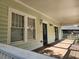 Inviting covered front porch with wood flooring, offering a cozy spot to enjoy the outdoors and a welcoming entrance at 998 Allene Sw Ave, Atlanta, GA 30310