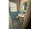 Bathroom featuring tiled walls and floors, a window, and a sink, with a retro design at 2541 Santa Barbara Nw Dr, Atlanta, GA 30318