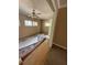 Bedroom with paneling, multiple windows and ceiling fan; evidence of flooring damage, needs repair at 2541 Santa Barbara Nw Dr, Atlanta, GA 30318