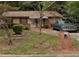 Cozy brick home featuring a well-maintained lawn and mature trees, offering a charming curb appeal at 2541 Santa Barbara Nw Dr, Atlanta, GA 30318