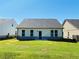 New home backyard with lush lawn, dark roof and a brick foundation at 2785 Lifford Way, Duluth, GA 30097