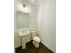 Well-lit half bathroom featuring a pedestal sink, decorative plants, and sleek fixtures at 2785 Lifford Way, Duluth, GA 30097