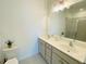 Bright bathroom featuring double sinks, a large mirror, and a glass-enclosed shower at 2785 Lifford Way, Duluth, GA 30097