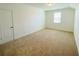 Bright bedroom with a large window and neutral carpeting provides a relaxing and comfortable living space at 2785 Lifford Way, Duluth, GA 30097