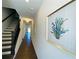 Inviting hallway with hardwood floors and a staircase with dark wood railings at 2785 Lifford Way, Duluth, GA 30097