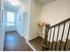 Hallway with hardwood floors, a staircase, and a glimpse of the front door with sidelights at 2785 Lifford Way, Duluth, GA 30097