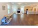 Inviting living room with hardwood floors, a cozy fireplace, and views of the modern kitchen and breakfast bar at 2785 Lifford Way, Duluth, GA 30097