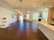 Open-concept living room with hardwood floors, fireplace, and modern chandelier at 2785 Lifford Way, Duluth, GA 30097