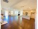 Open-concept living room with hardwood floors, a fireplace, and a view of the modern kitchen with an eat-in island at 2785 Lifford Way, Duluth, GA 30097