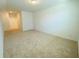 Spacious living room with neutral carpeting, great natural light, and convenient access to other rooms at 2785 Lifford Way, Duluth, GA 30097