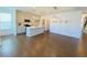 Open-concept living room featuring hardwood floors, access to the kitchen, and plenty of natural light at 2785 Lifford Way, Duluth, GA 30097