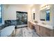 Luxurious bathroom with a freestanding tub, dual vanity sinks, and an elegant glass shower at 2179 Marann Ne Dr, Atlanta, GA 30345