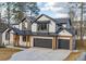 Stunning two-story home featuring a three-car garage, complemented by natural wood accents and a manicured lawn at 2179 Marann Ne Dr, Atlanta, GA 30345