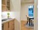 Stylish wet bar with wood cabinets and sink, adjacent to a dining area with seating for two at 2179 Marann Ne Dr, Atlanta, GA 30345