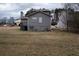 View of the back of a two-story gray home on a large grassy lot at 3934 Conley Downs Ln, Decatur, GA 30034