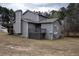 A gray two-story home features a quaint wooden back deck and chimney at 3934 Conley Downs Ln, Decatur, GA 30034