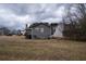 A gray two-story home with a back deck and a large grassy yard at 3934 Conley Downs Ln, Decatur, GA 30034