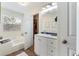 Bright bathroom featuring a soaking tub, white cabinets, and modern fixtures at 3934 Conley Downs Ln, Decatur, GA 30034