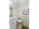 Bright bathroom featuring a modern vanity, tiled floors, and a window offering natural light at 3934 Conley Downs Ln, Decatur, GA 30034